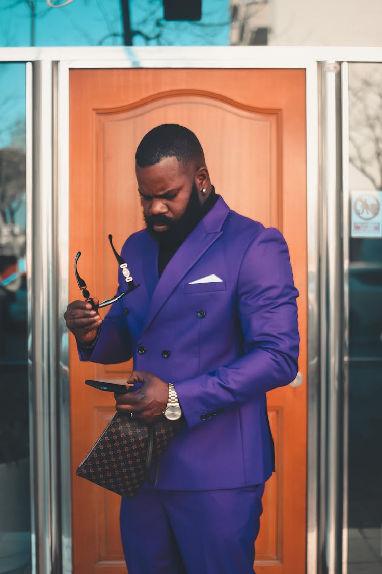 Man In Purple Suit Using Smart Phone