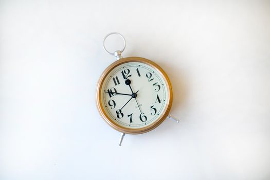 Vintage table clock with Roman numerals on white background, perfect for concept of time.
