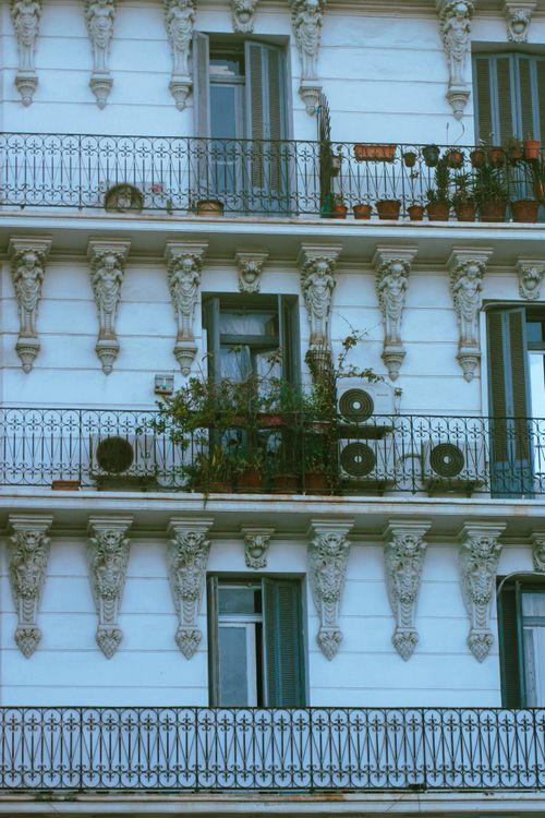 Free Facade of a classic apartment building in Algiers with ornate design and balconies. Stock Photo