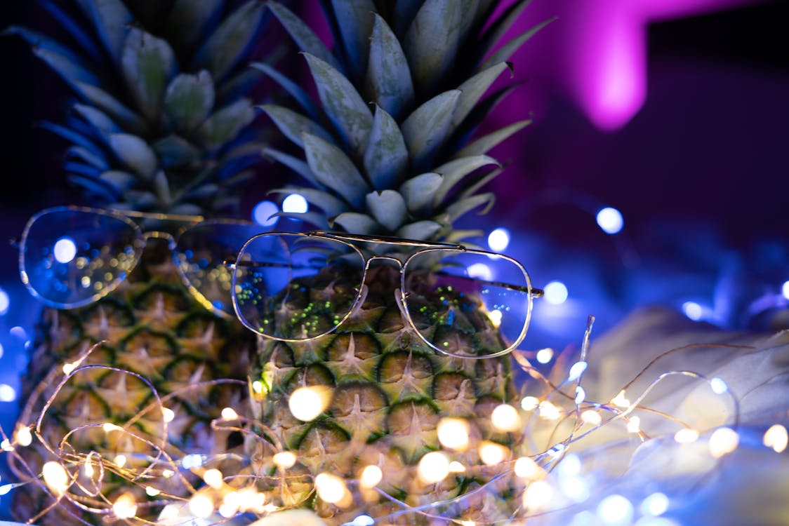 Free stock photo of camera, fairy lights, gold glasses