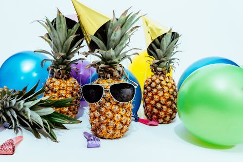 Free Photo Of Three Pineapples Surrounded By Balloons Stock Photo