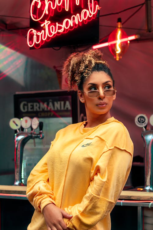 Woman in Yellow Sweatshirt Wearing Sunglasses