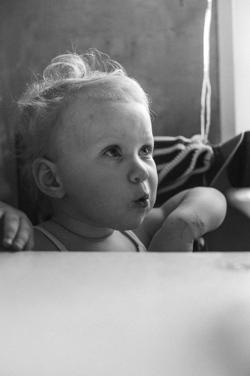 Free Expressive black and white portrait of a young toddler looking curious. Stock Photo
