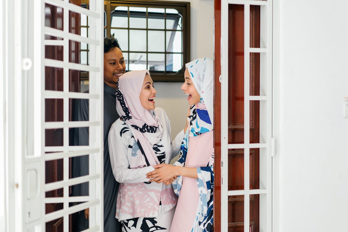 Free Photo Of Women Standing By The Door Greeting Each Other Stock Photo