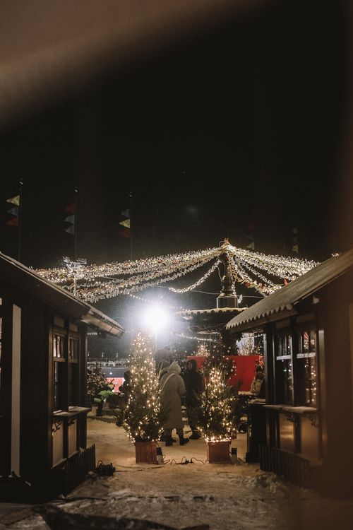Free Charming Christmas market scene with festive lights and winter atmosphere during the night. Stock Photo