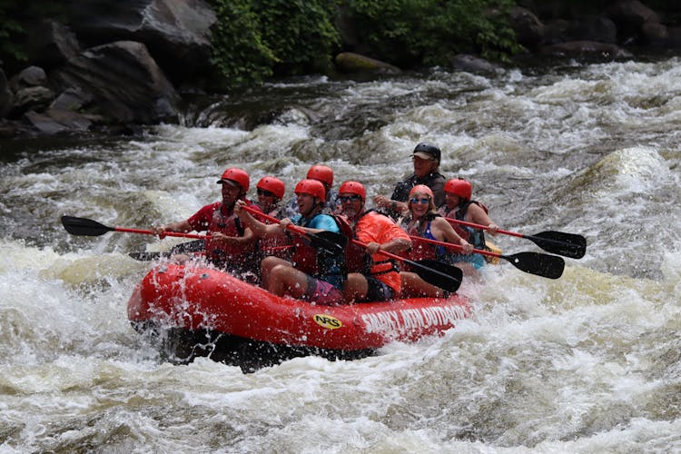 People With Paddles On Boat