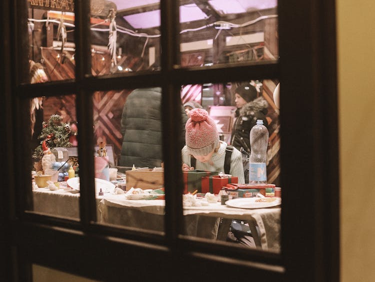 Child Looking At Christmas Themed Display In Store