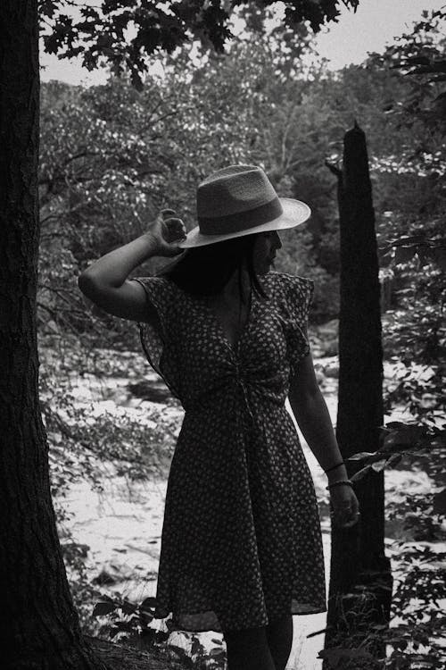 Black and White Photo of a Woman in the Forest
