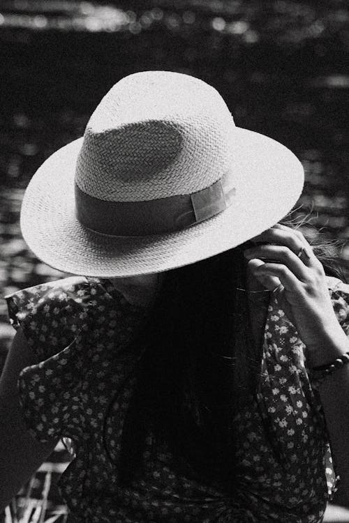 Black and White Photo of a Woman Wearing Sun Hat