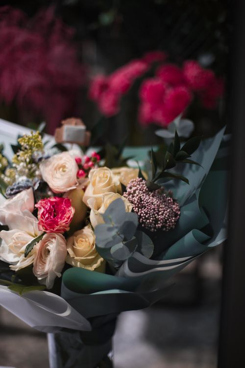 A Purse and a Bouquet of Red Roses · Free Stock Photo