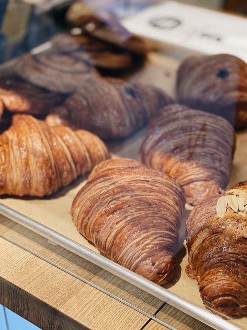 Free Delicious croissants showcased in a bakery setting, ready to enjoy. Stock Photo