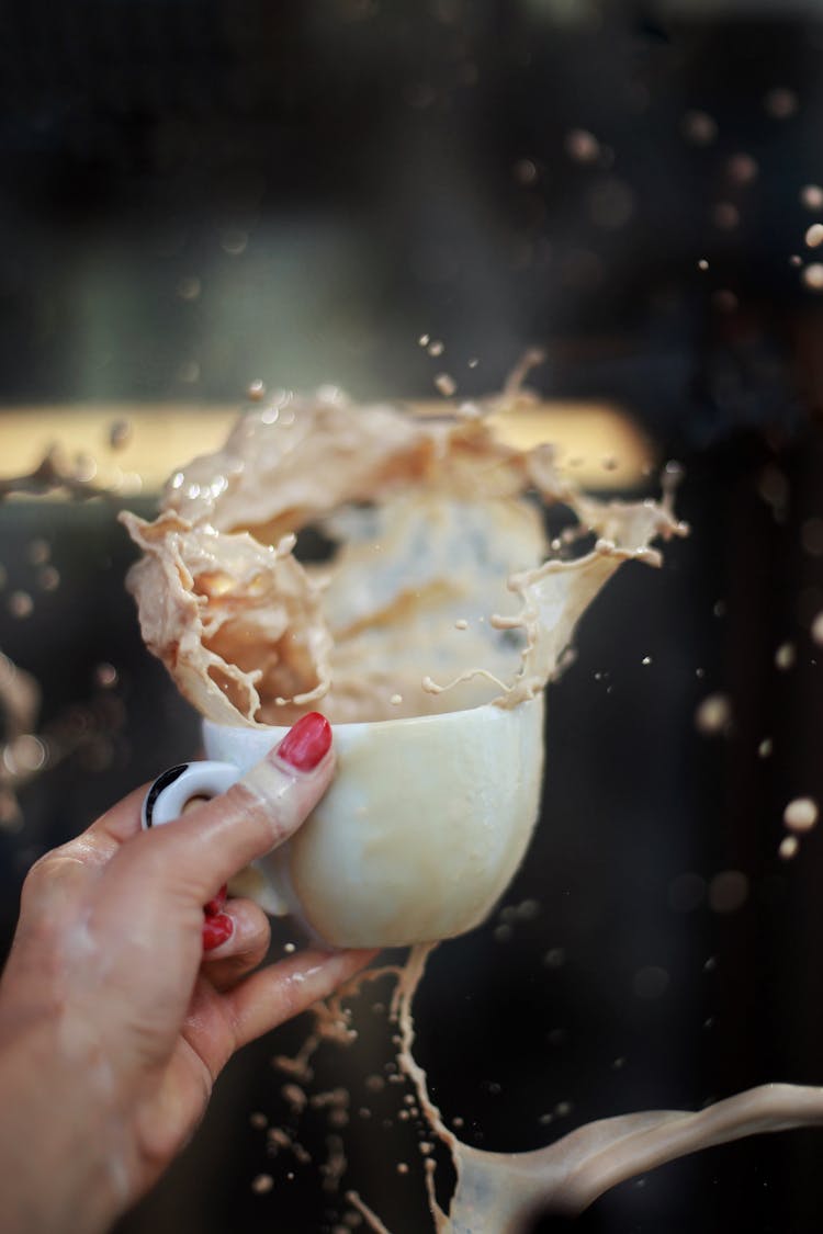 Spilling Coffee In Cup