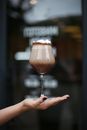 Close-up of Womans Hand Holding Glass of Cold coffee Drink