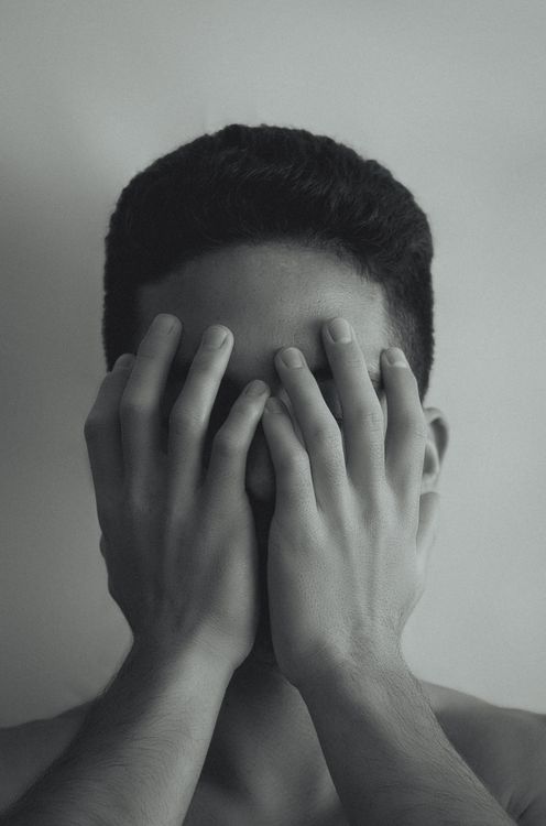 Young Man Covering His Face with His Hands · Free Stock Photo