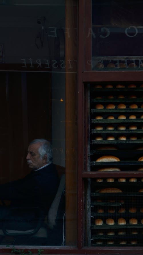 Man Sitting in Bakery