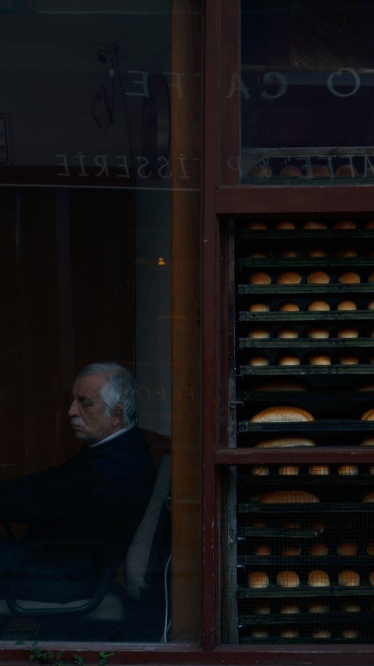 Man Sitting In Bakery