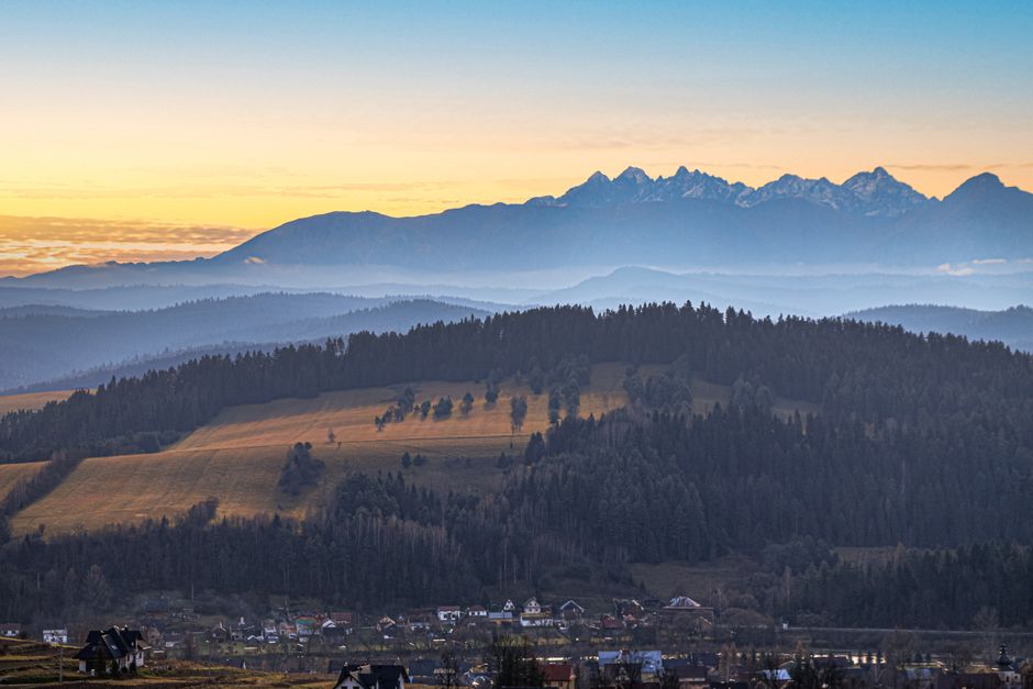 Breathtaking sunrise view of the rolling hills and mountains in Lesser Poland Voivodeship, Poland.