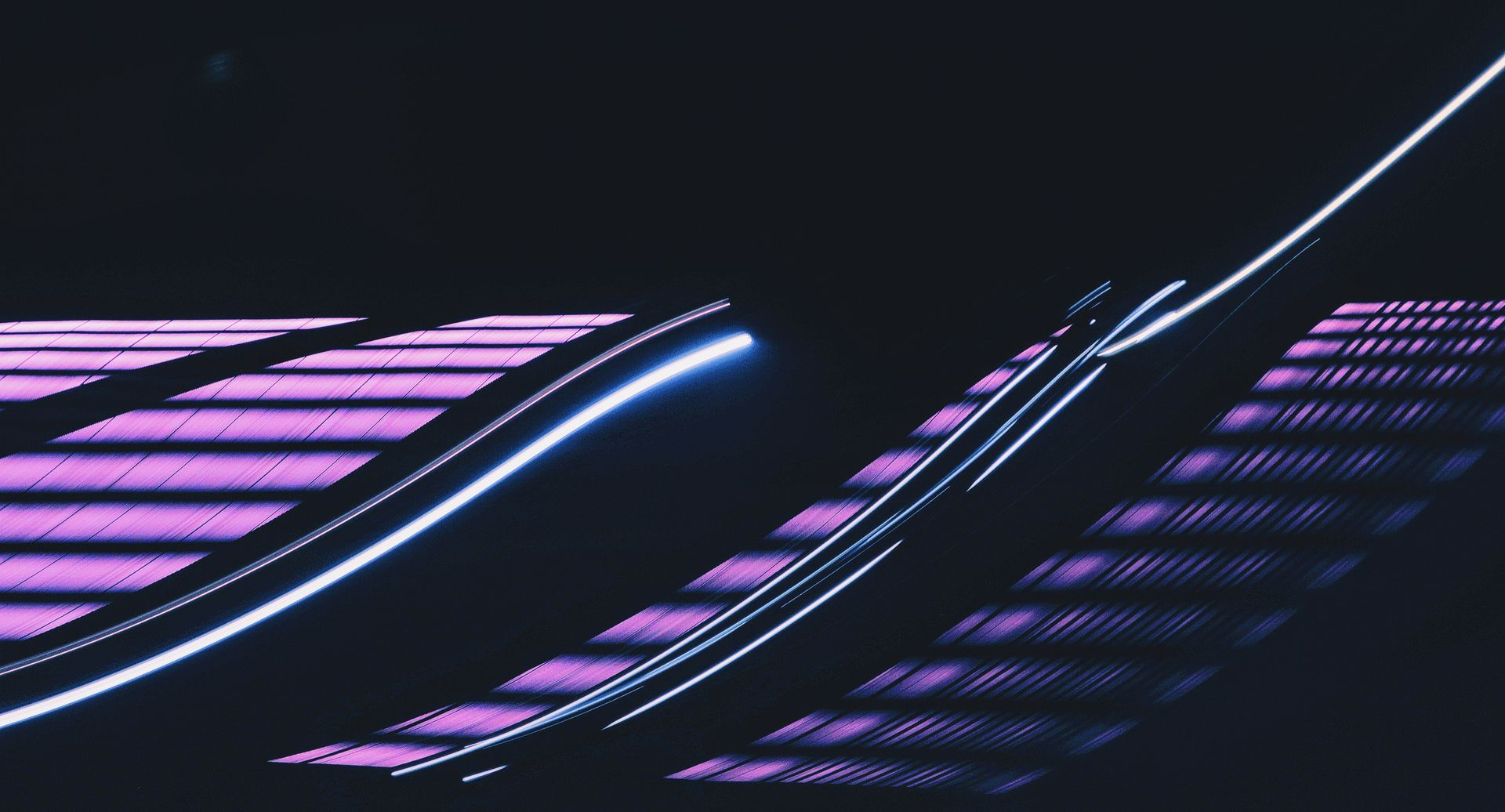 Vibrant abstract image of neon light trails against a dark background