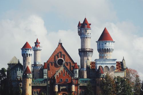 Free A stunning medieval castle under a bright sky, featuring intricate turrets and colorful spires. Stock Photo