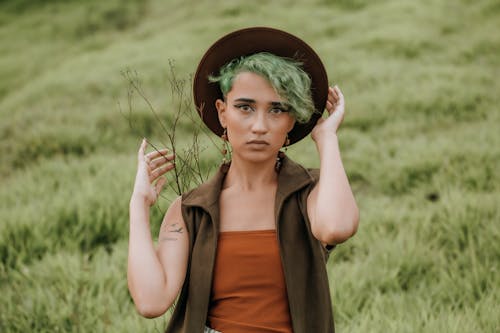 Woman in Hat Posing on Grass