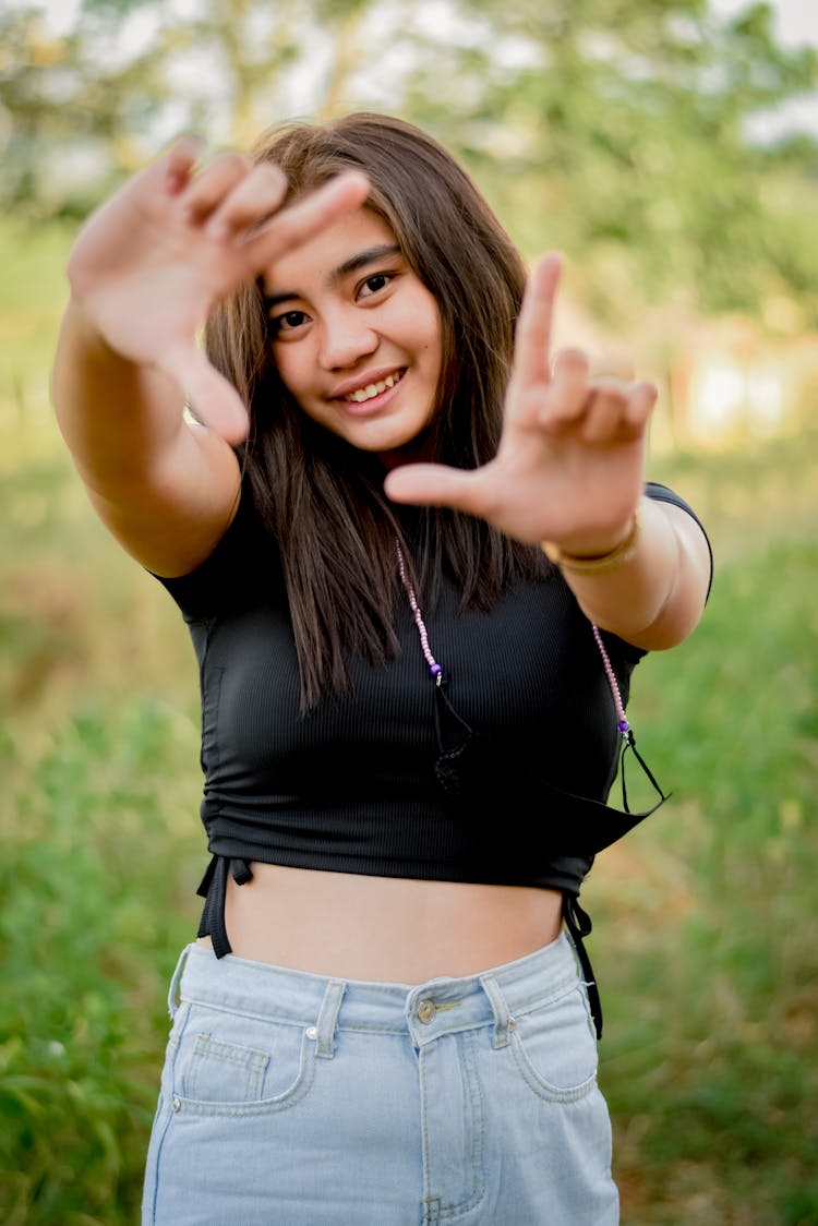 A Young Woman Framing With Her Hands