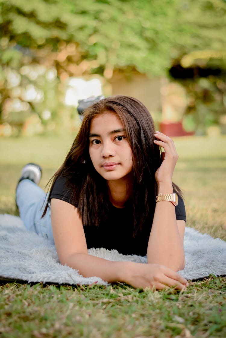 Woman Posing On Blanket On Grass