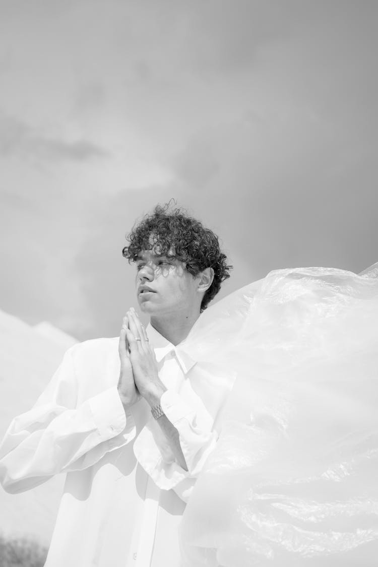 Man With Curly Hair And In White Shirt