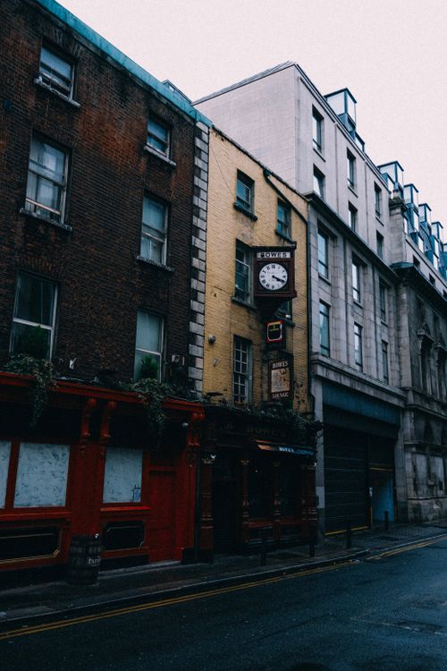 Free Charming urban street view featuring historic red brick and yellow buildings. Stock Photo