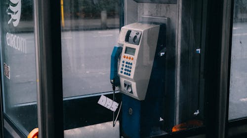 A Coin Operated Telephone Inside a Booth