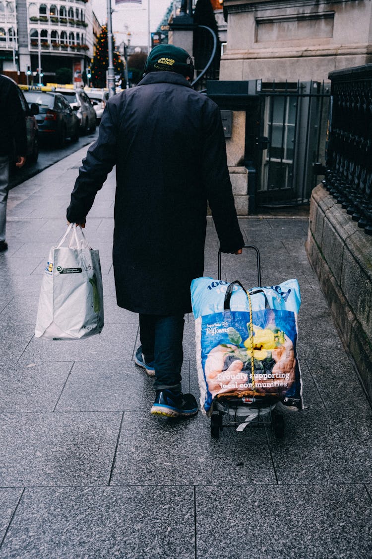 Person Carrying Shopping Bags