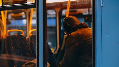Man Sitting in Empty Public Bus