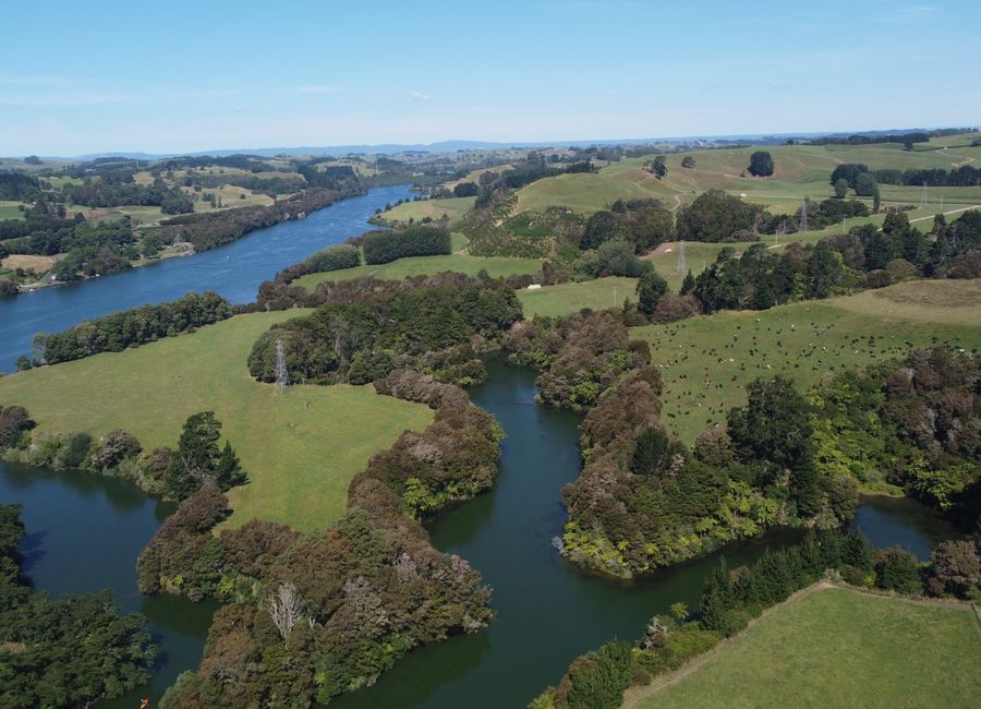 Explore the lush landscapes of Waikato River in Maungatautari, New Zealand from above.