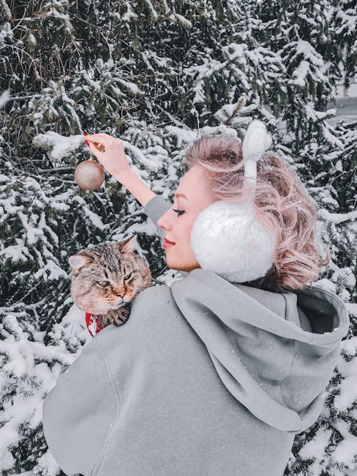 Woman in Gray Hoodie Jacket Holding Cat