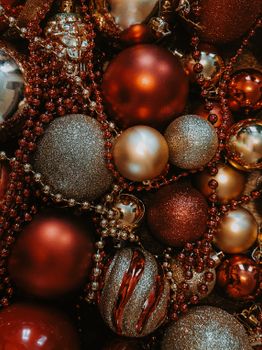 Close-up of red and gold Christmas baubles adorned with sparkling beads, creating a festive holiday atmosphere.
