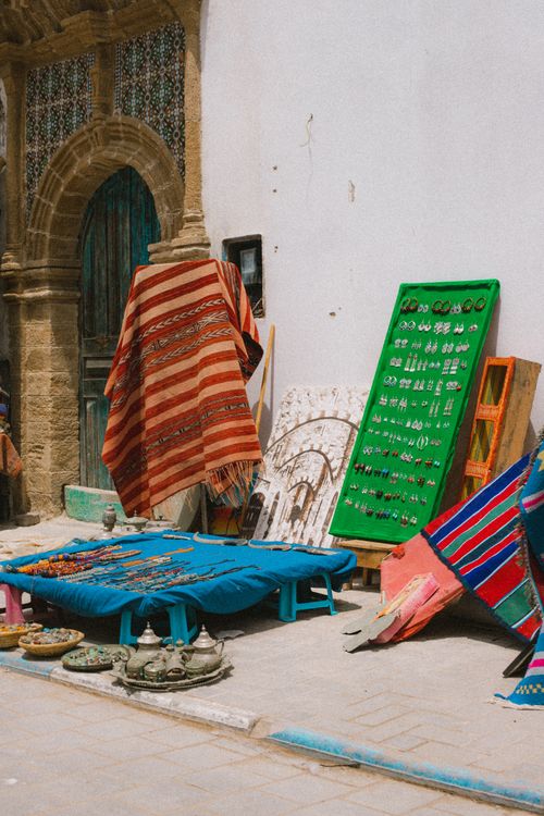 Free Street market stall displaying vibrant textiles and handcrafted jewelry. Stock Photo