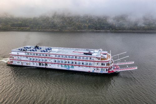 Free Paddlewheeler boat cruising the misty Mississippi River near Maple Springs, MN during autumn. Stock Photo