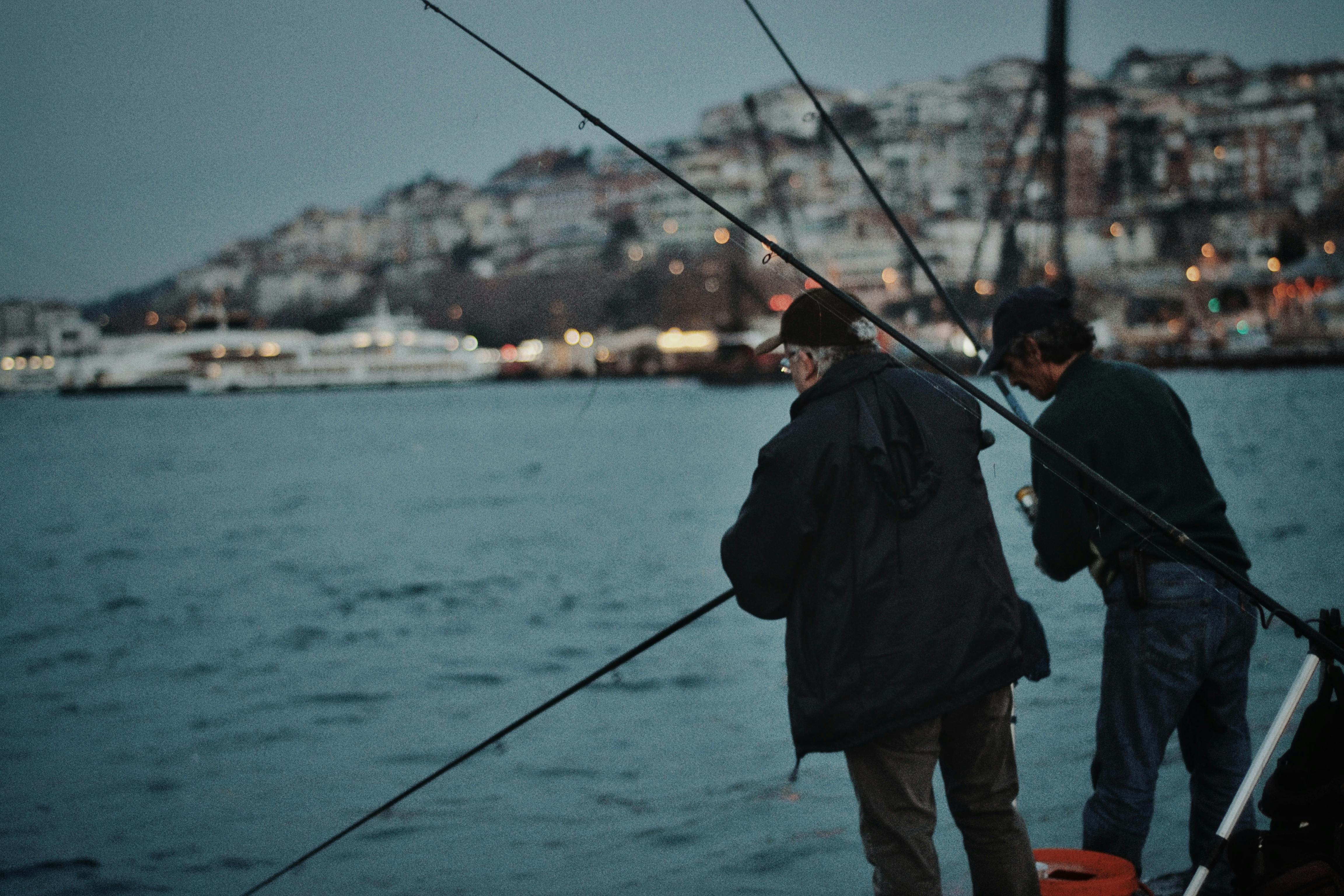 Men in Jackets Holding Fishing Rods · Free Stock Photo