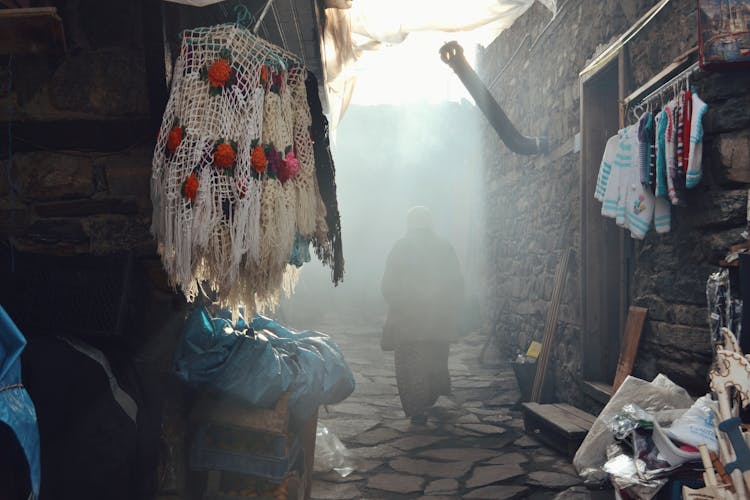 Sunlight Over Woman Walking In Town