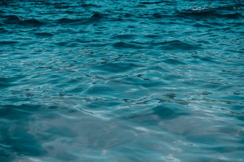 Free Tranquil ocean waves creating ripples in the clear waters of Arraial do Cabo, Brazil. Stock Photo