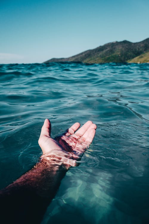 Free Person Soaking On Body Of Water Stock Photo