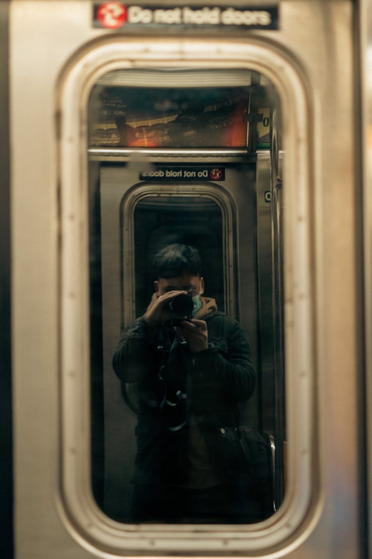 Photographer Taking Picture Of The Window Of A Train