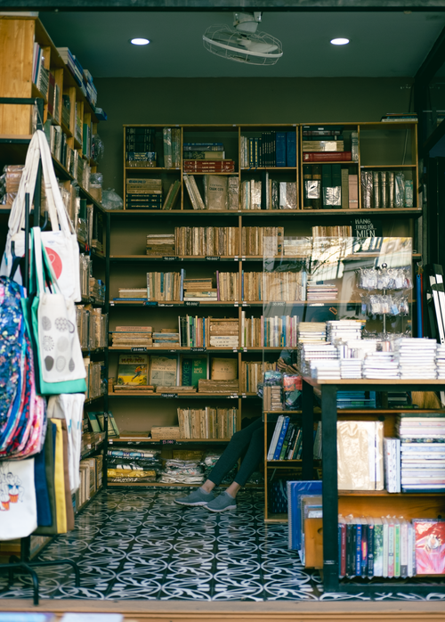 Free Discover a cozy Vietnamese bookstore with vibrant shelves filled with books and accessories. Stock Photo