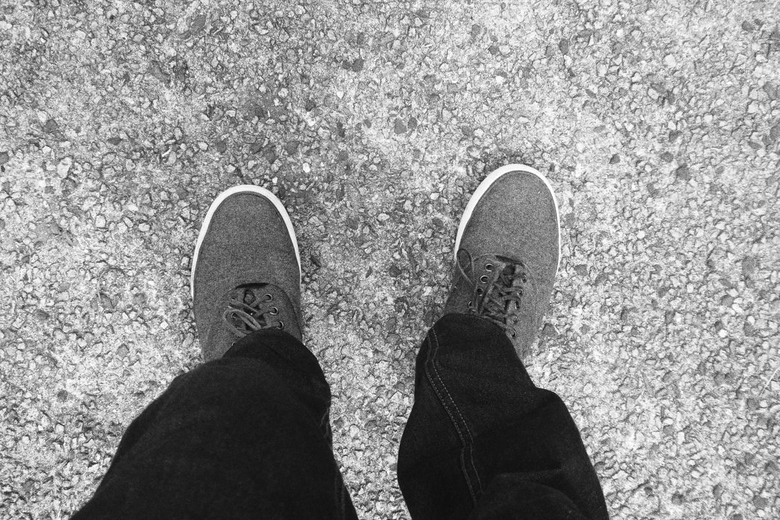 Grayscale Photo of a Person's Shoes · Free Stock Photo