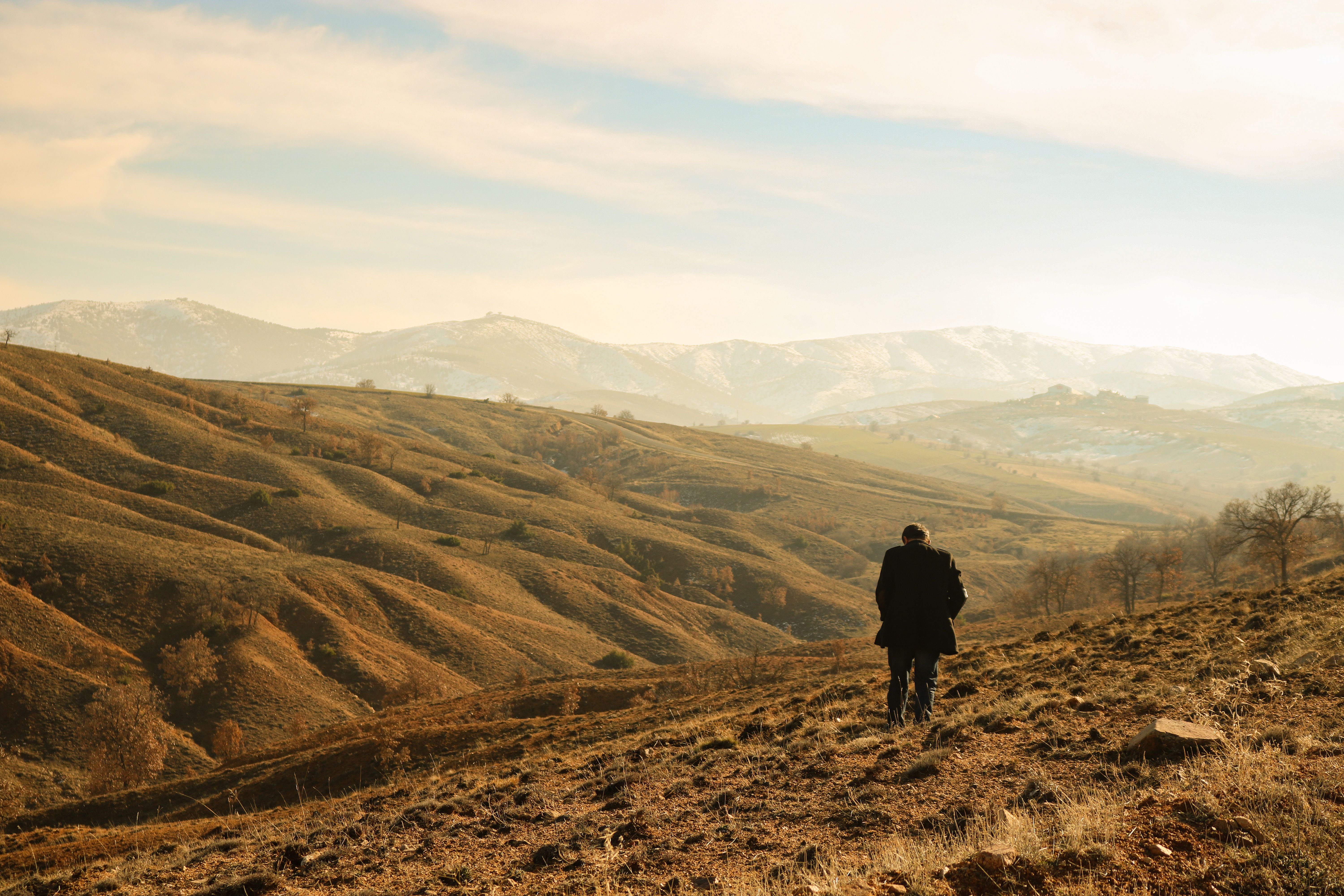 Traveler overlooking a serene landscape at sunrise