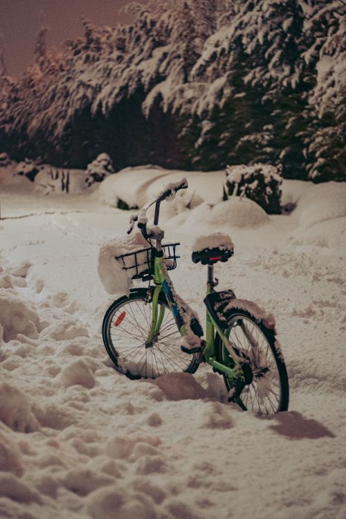 Free A bicycle parked outdoors in Konya during a heavy snowfall, surrounded by thick snow. Stock Photo