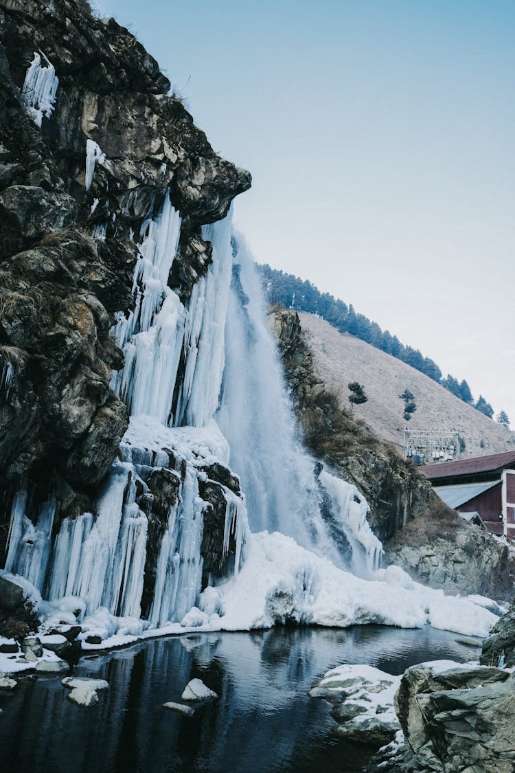 Landscape With Rock And Frozen Waterfall