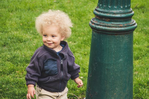 Free Toddler Wearing Jacket Beside the Light Post Stock Photo