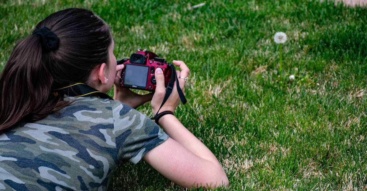 Woman in Camouflage T-shirt Holding Dslr Camera