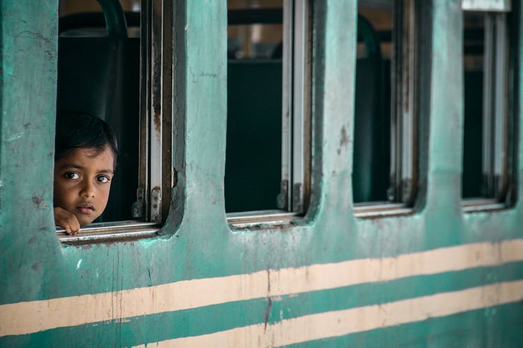 Child Looking Out Of A Train Window 