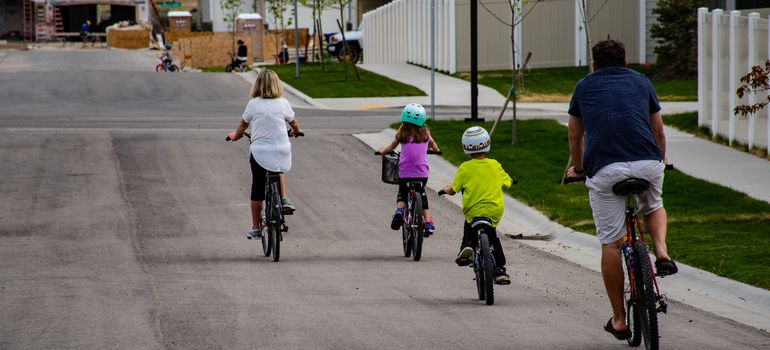 Family cycling through a Mesa neighborhood